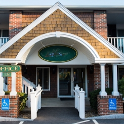 Entrance to Juniper Hill Inn with handicapped parking spaces in front of building in Ogunquit, ME