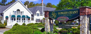 Gorges Grant Hotel entrance sign near American flag in front of hotel in Ogunquit, ME