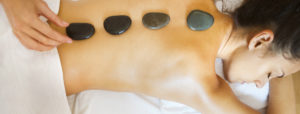 Woman Laying on Stomach at Ogunquit, ME Hotel Receiving Hot Stone Massage
