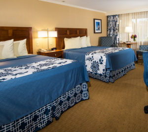 Two Queen Beds with Blue Blankets and Linens at Ogunquit Accommodations